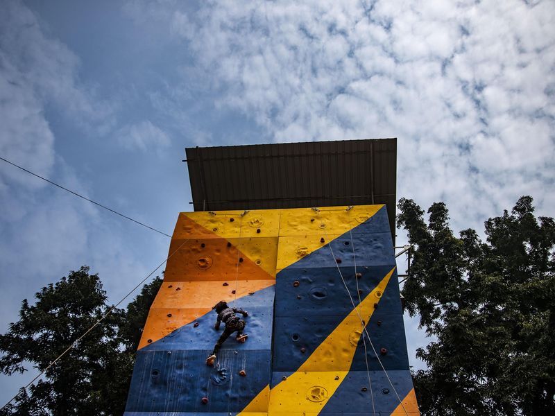 A boy climbs an artificial wall
