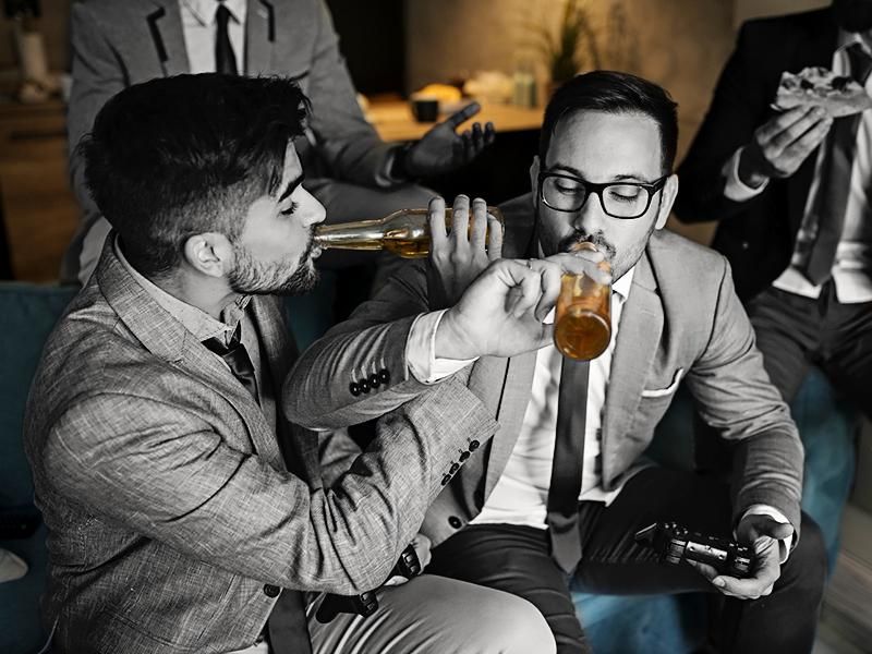 A group of young business men drinking