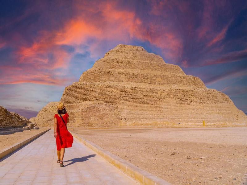 A young tourist in a red dress at the Stepped Pyramid of Djoser