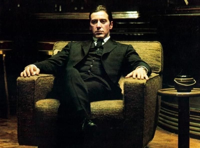 Al Pacino sitting in The Godfather, Part II