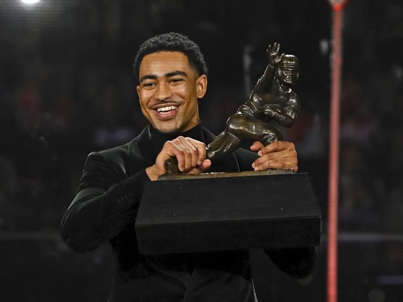 Alabama quarterback Bryce Young holds Heisman Trophy at award ceremony