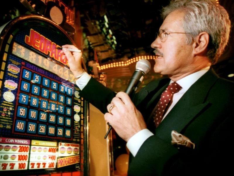 Alex Trebek signing a slot machine in 1999