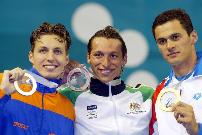 Alexander Popov, right, shows his gold medal