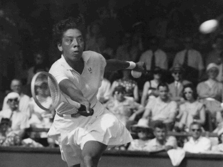 Althea Gibson hitting a volley on the tennis court