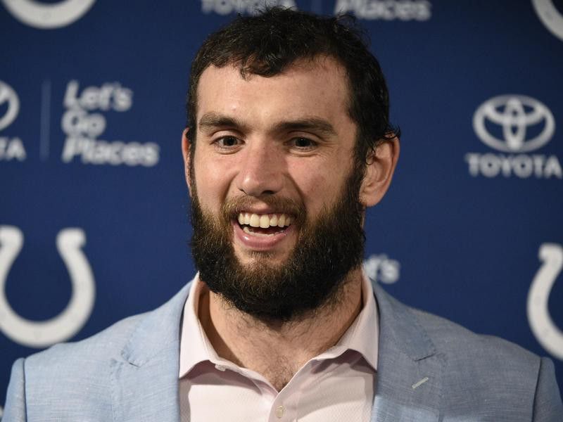 Andrew Luck talks with the media
