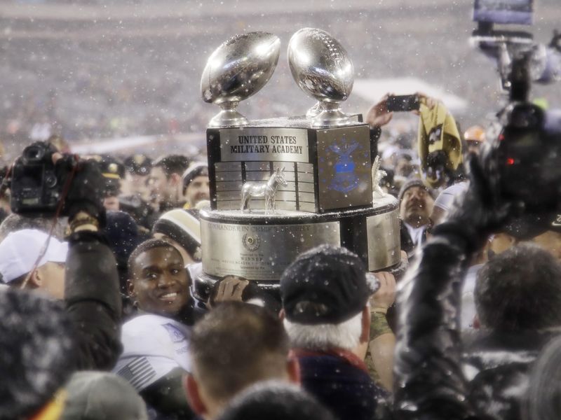 Army's Ahmad Bradshaw holds up Commander-in-Chief's Trophy after defeating Navy in NCAA college football game