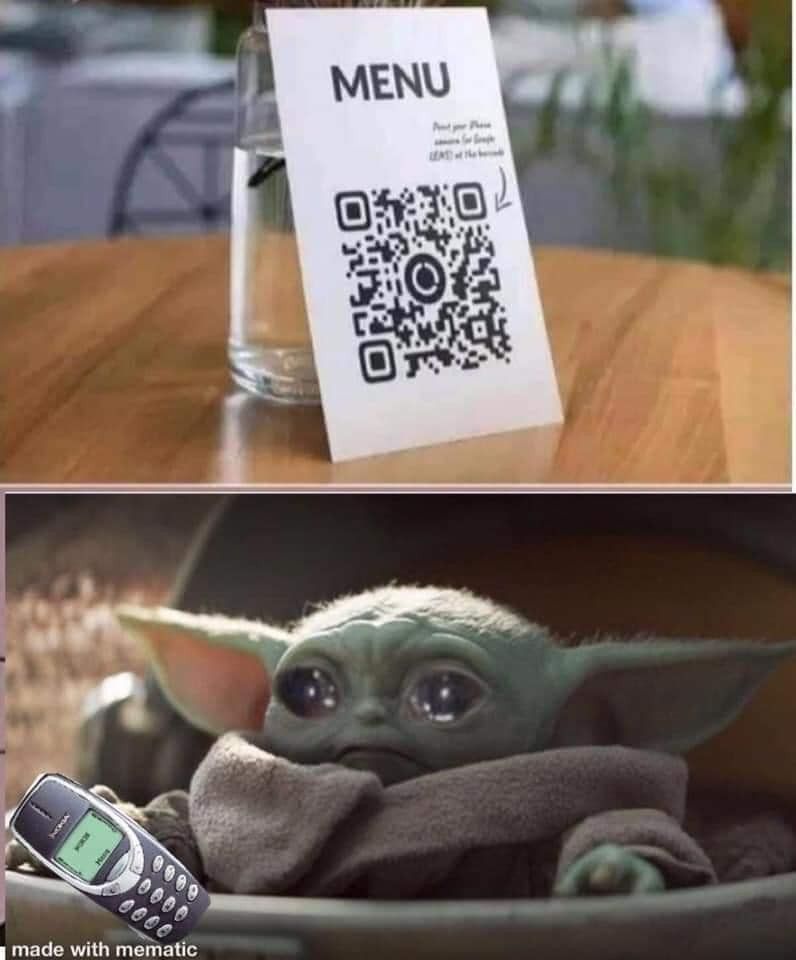 Baby Yoda looking at a QR code menu