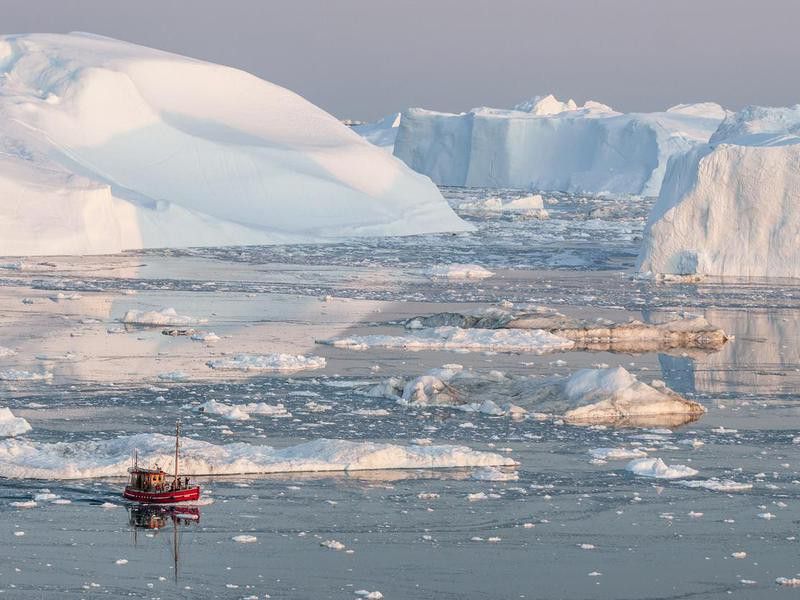 Boat among iceberg in Greenland