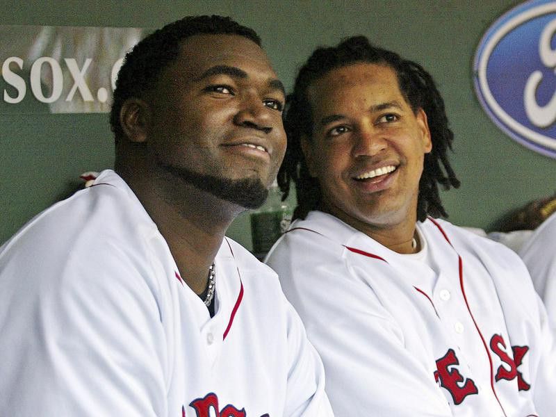 Boston Red Sox' David Ortiz sits with teammate Manny Ramirez