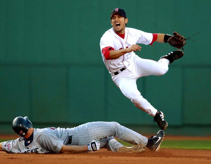 Boston Red Sox shortstop Nomar Garciaparra leaps after throwing the ball