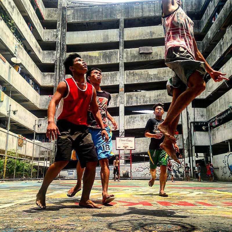 Boys play basketball at the Taguig Tenement