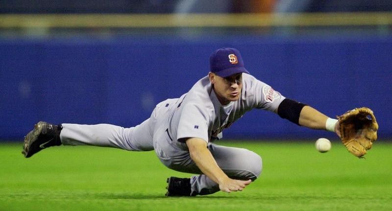 Bret Boone dives to field a ball hit by Milwaukee Brewers