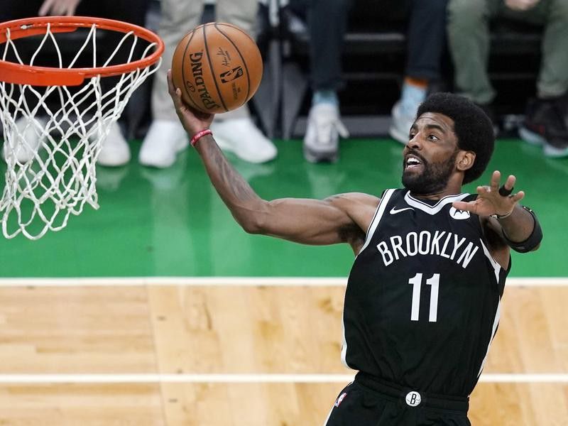 Brooklyn Nets guard Kyrie Irving scores against Boston Celtics