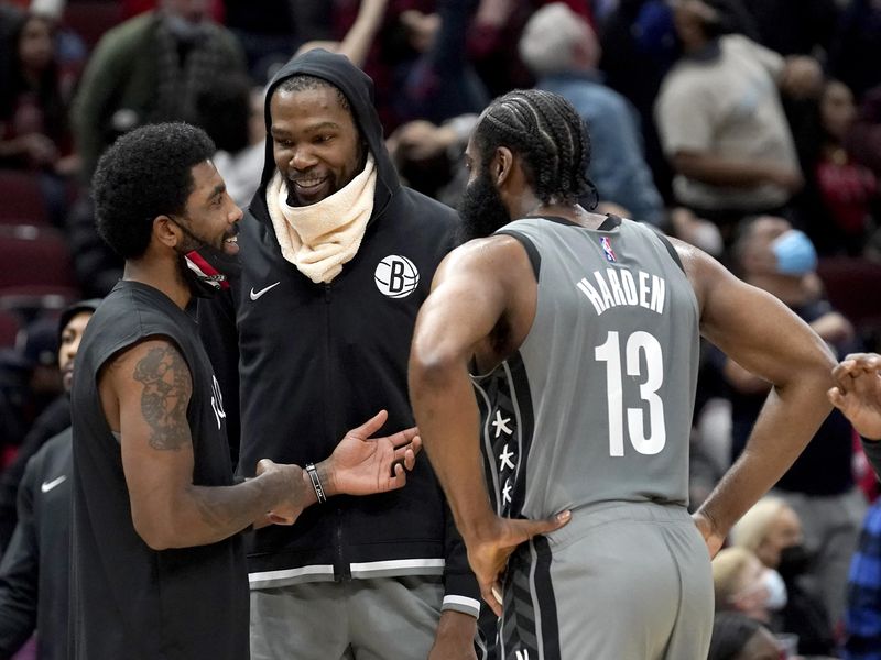 Brooklyn Nets' Kevin Durant smiles with teammates Kyrie Irving