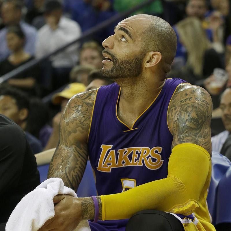 Carlos Boozer sits on bench and looks out