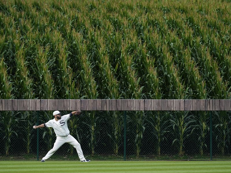 Chicago White Sox pitcher Lance Lynn warms up in outfield before Field of Dreams game