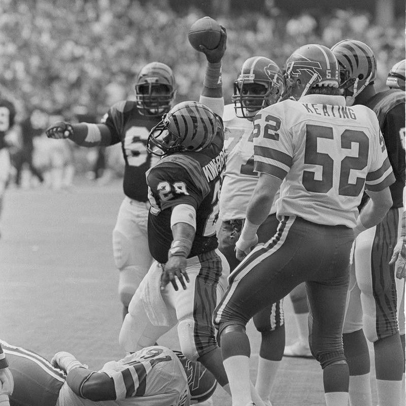 Cincinnati Bengals fullback Larry Kinnebrew stands over Buffalo Bills defensive end Ken Johnson as he spikes football