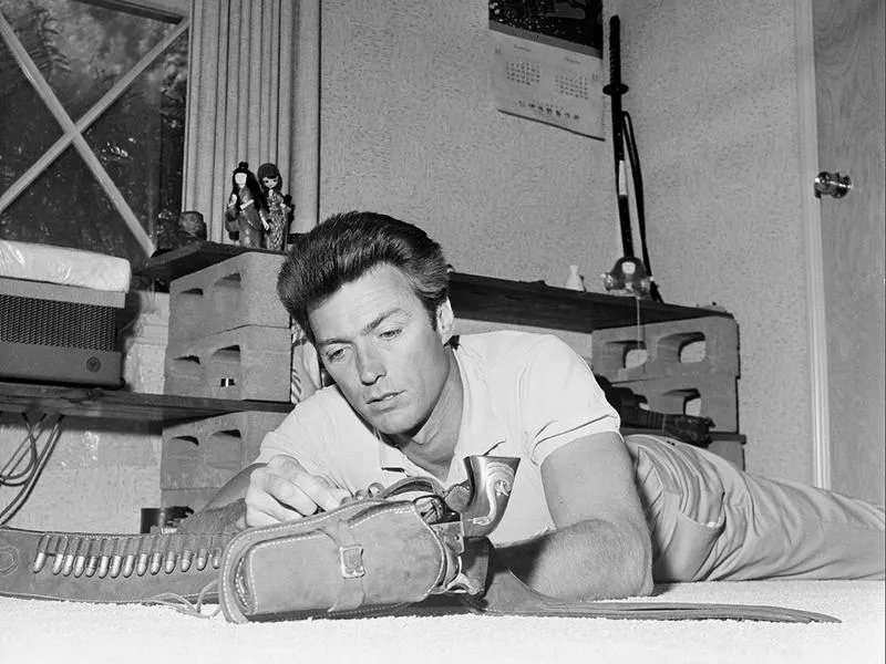Clint Eastwood loads his new Colt revolver at his home in Los Angeles in 1962.