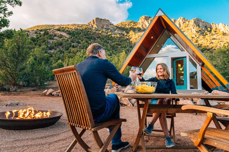 Couple sharing a toast in front of tiny home