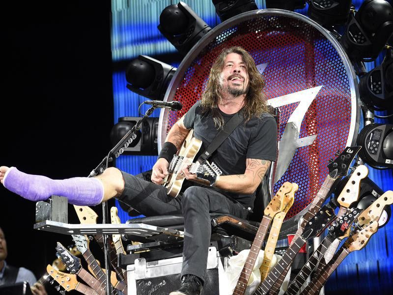 Dave Grohl with a broken leg on his custom throne