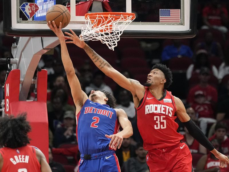 Detroit Pistons guard Cade Cunningham shoots as Houston Rockets center Christian Wood defends
