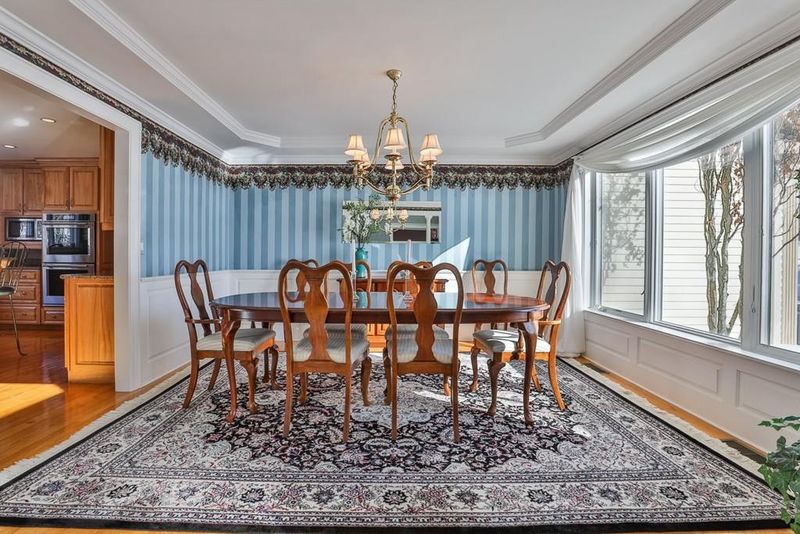 Dining room with blue striped wallpaper