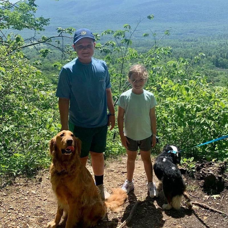 Dog photobombing a family hike