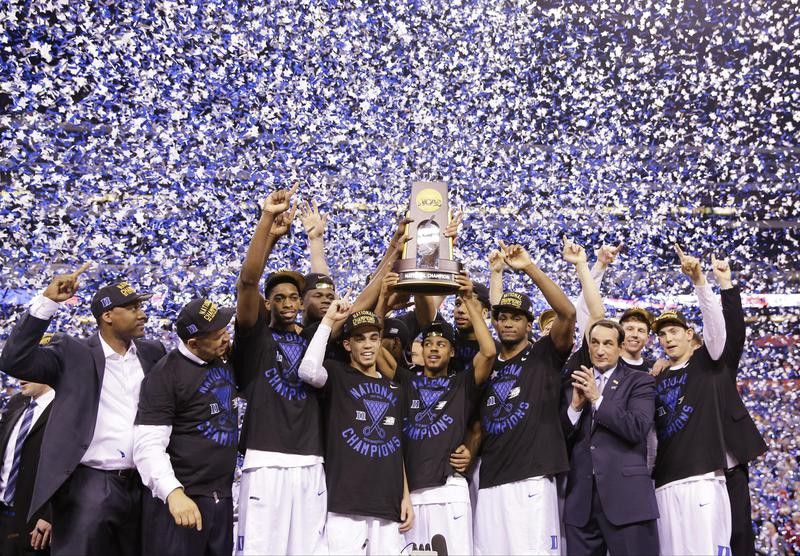 Duke players celebrate with trophy after win over Wisconsin