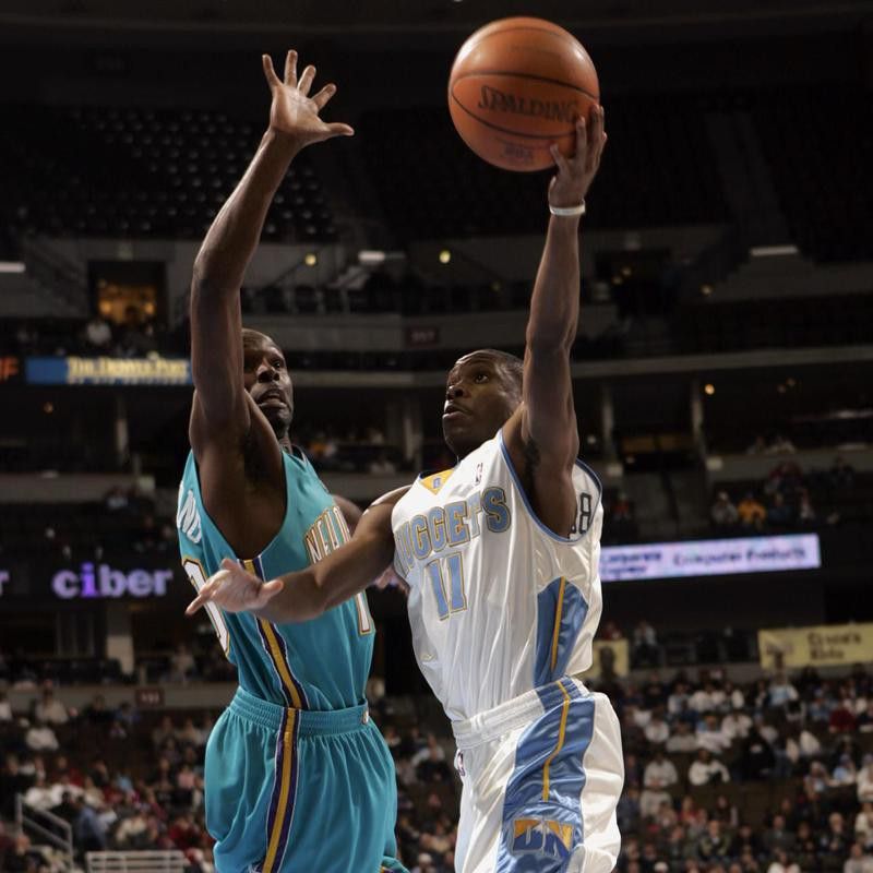 Earl Boykins goes up for a shot against New Orleans Hornets guard Darrell Armstrong