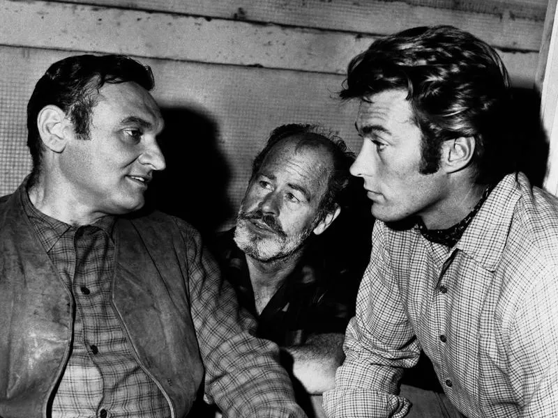 Clint Eastwood performs with Frankie Lane (left), and Paul Brinegar on the set of "Rawhide" in 1961. By the end of the show's run, Eastwood was making $100,000 per season.