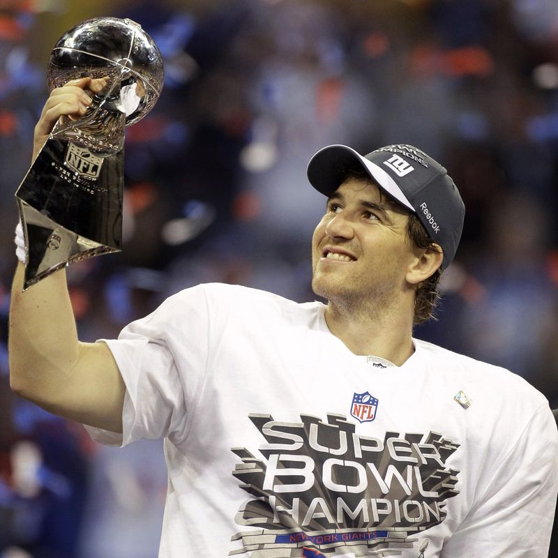 Eli Manning.celebrates with the Vince Lombardi Trophy