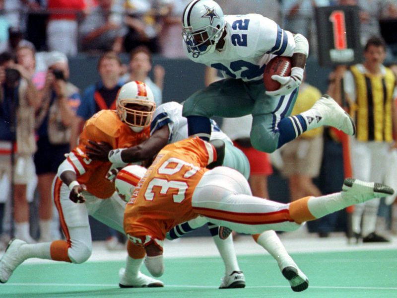 Emmitt Smith leaps over Tampa Bay Buccaneers free safety Harry Hamilton