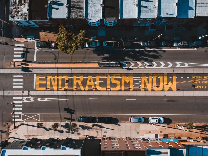 End racism now sign