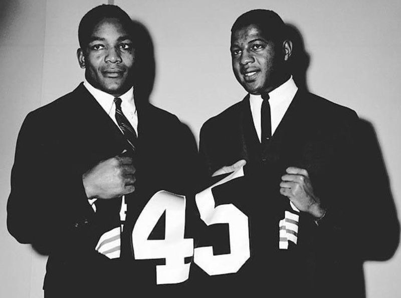 Ernie Davis holding up jersey #45
