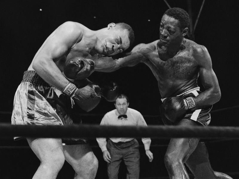 Ezzard Charles delivers hard right to midsection of Joe Louis