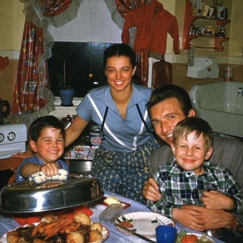 Family of four having dinner in the 1950s