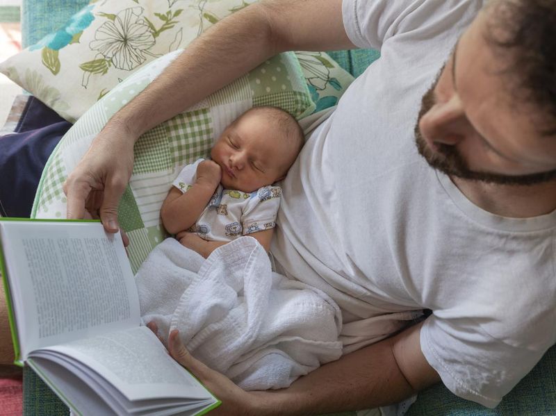 Father Reading with Baby on Lap