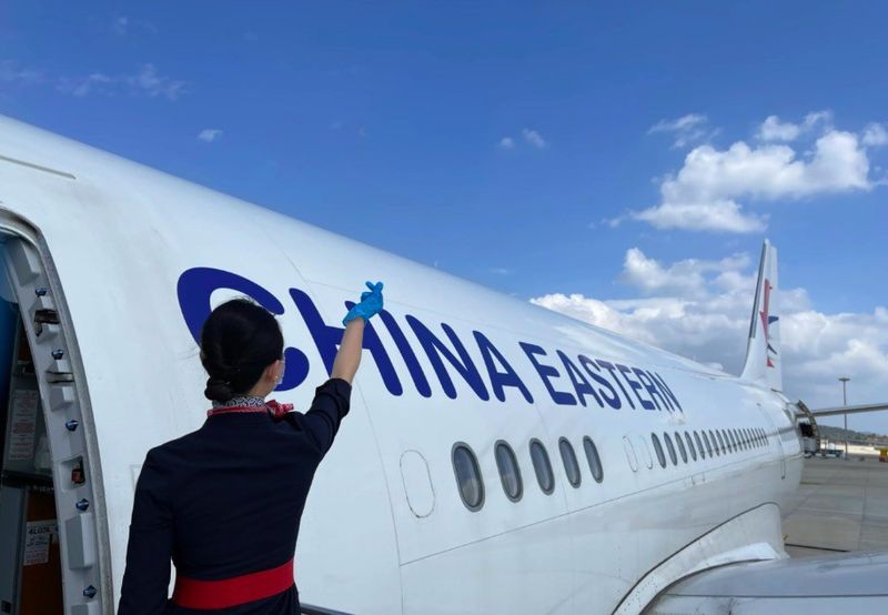 Flight attendant outside China Eastern plane
