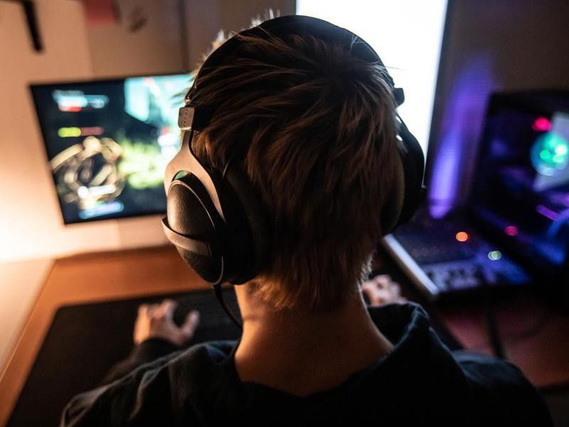 Gamer with Headset on Playing Online Video Games