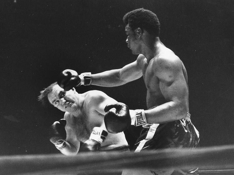 George Foreman seen throwing right at Chuck Wepner