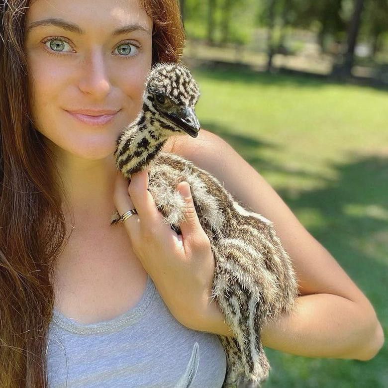 Girl with baby emu pet