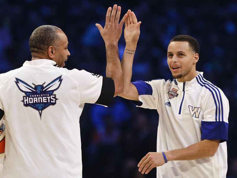 Golden State Warriors' Stephen Curry celebrates with father, Dell Curry