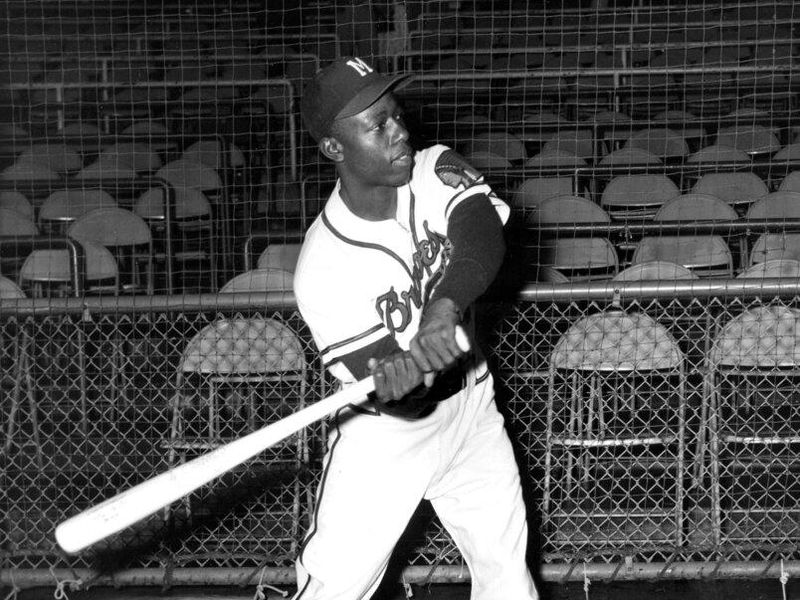 Hank Aaron swinging a bat in 1956