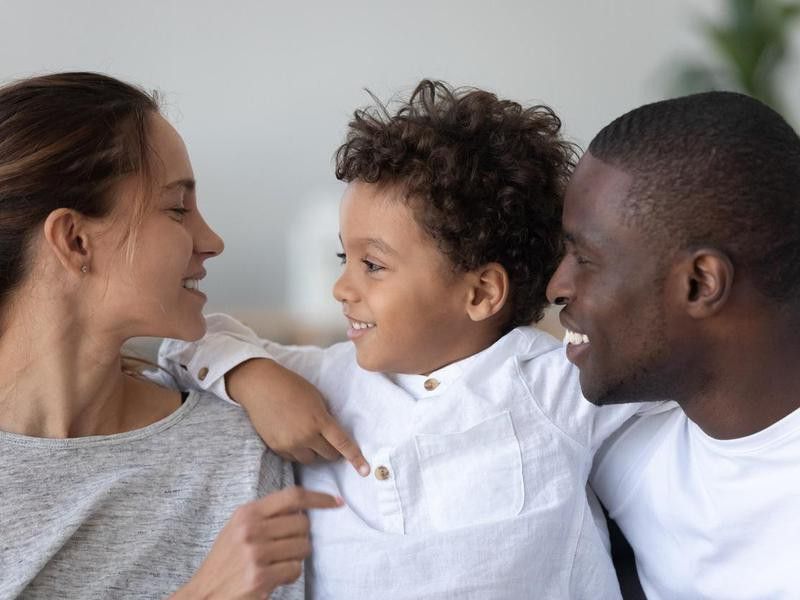 Happy multiethnic family of three have fun at home