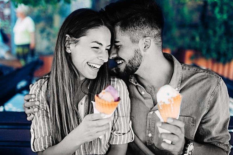 Happy young couple having date and eating ice cream