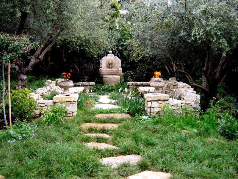 Home garden with stone pathway, stone walls and fountain
