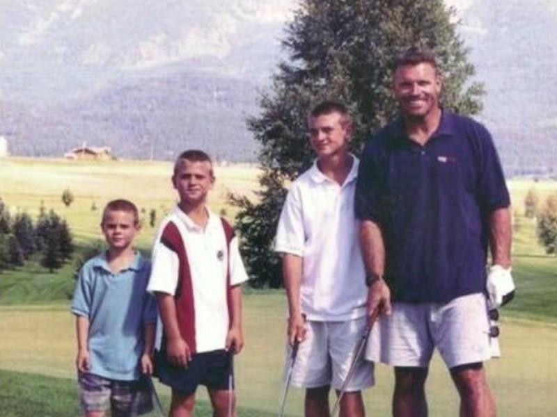 Howie poses with sons Chris, Kyle, and Howie Jr. while playing golf