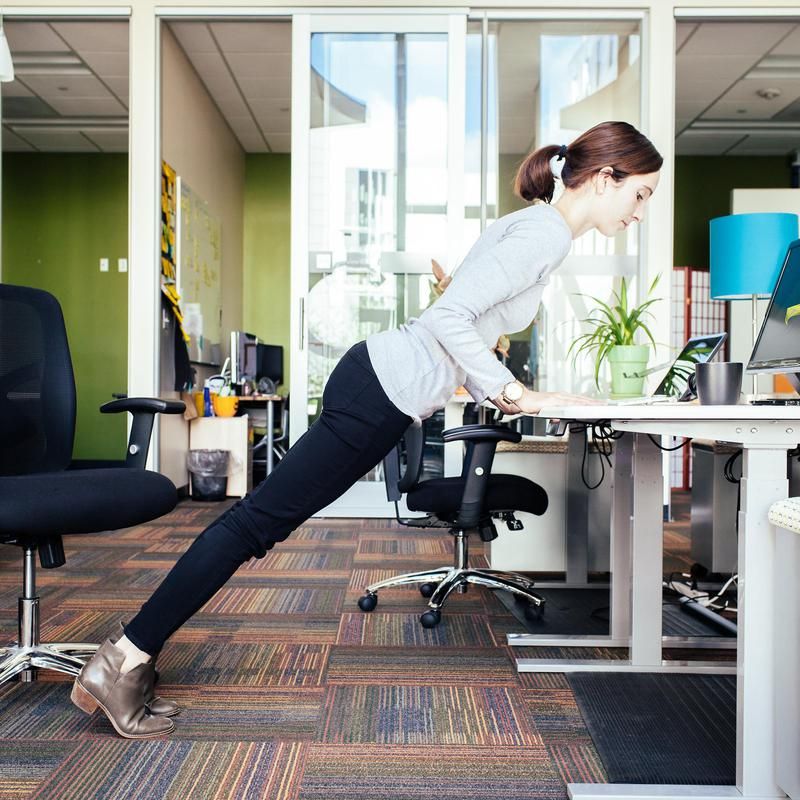 11 Yoga Poses You Can Do at Your Desk | Work + Money