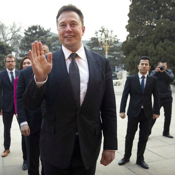 FILE - In this Jan. 9, 2019, file photo, Tesla CEO Elon Musk, center, waves as he waits for a meeting with Chinese Premier Li Keqiang at the Zhongnanhai leadership compound in Beijing. A rich list by wealth compiler Hurun Report shows the market meltdowns in 2018 obliterated $1 trillion in wealth, with more than 212 of China's richest individuals losing their dollar billionaire status. (AP Photo/Mark Schiefelbein, Pool, File)