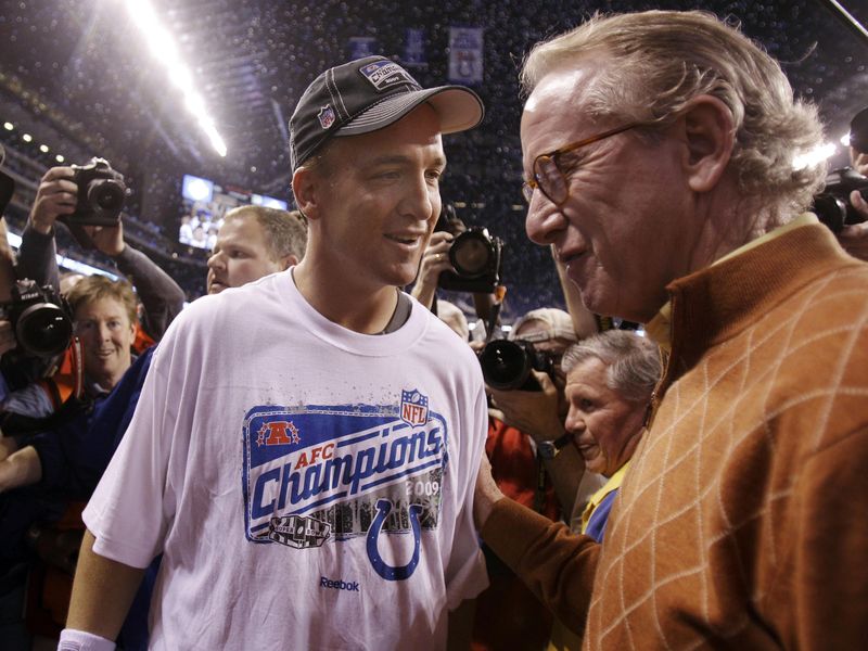 Indianapolis Colts quarterback Peyton Manning talks with father Archie Manning after AFC Championshi